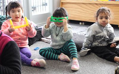 children on mat with fun glasses at daycare