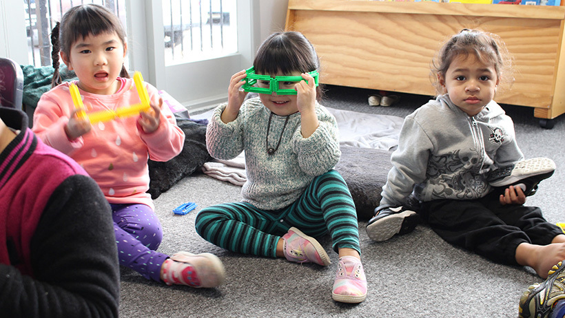 children on mat with fun glasses at daycare