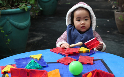 baby playing with blocks at daycare