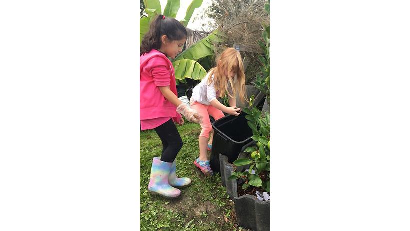 children in garden for sustainability at daycare