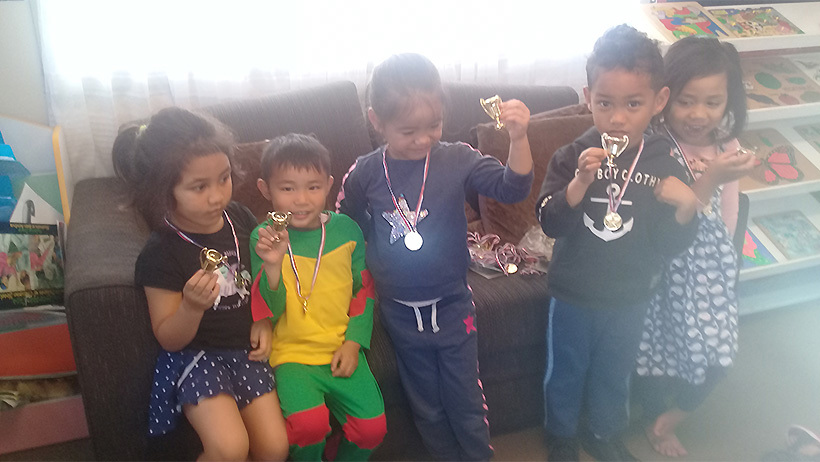 Learning Adventures Mangere East daycare children showing their medals