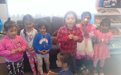 Learning Adventures Mangere East daycare children showing their medals